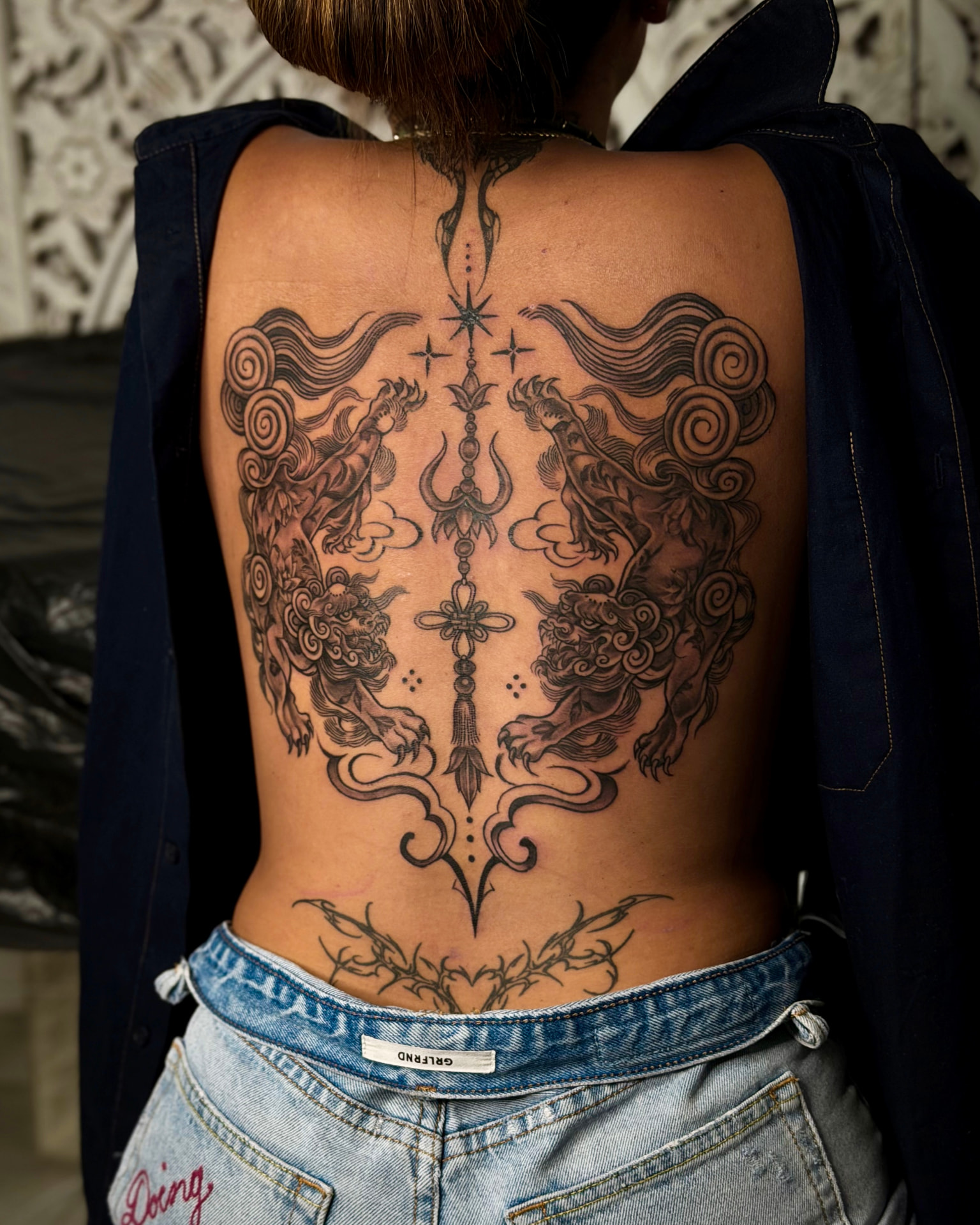 Full back tattoo by Wilson with twin guardian lions